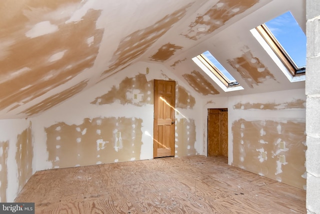 additional living space featuring lofted ceiling