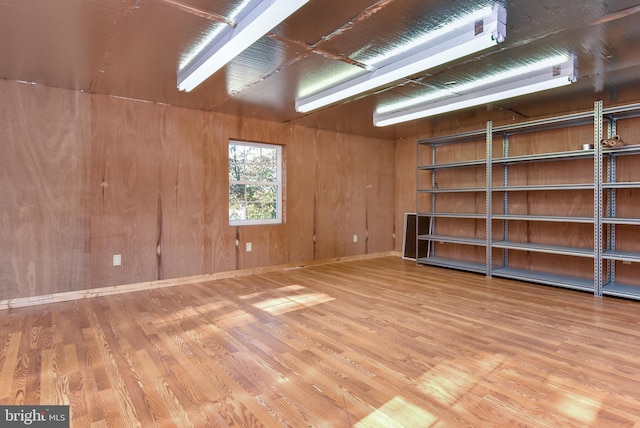 interior space featuring wood walls and hardwood / wood-style flooring