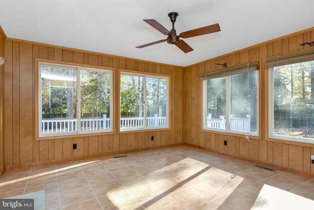 unfurnished sunroom featuring plenty of natural light and ceiling fan