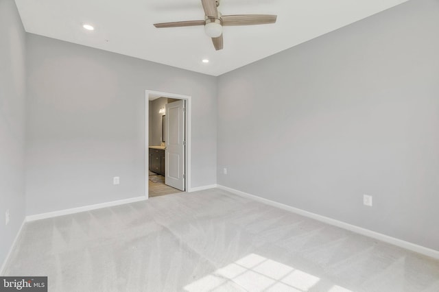 carpeted spare room with ceiling fan