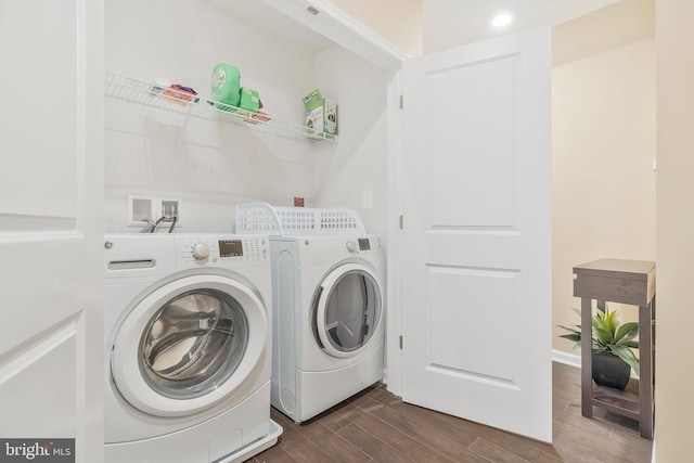 laundry area featuring washer and dryer and dark hardwood / wood-style floors