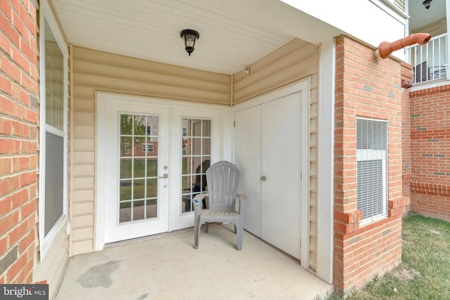 property entrance featuring french doors and a patio area