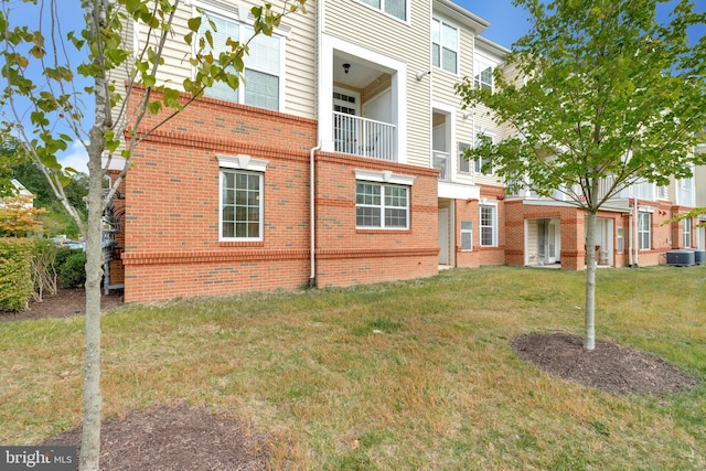 exterior space featuring central AC unit and a yard