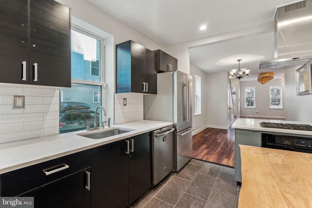 kitchen featuring stainless steel appliances, extractor fan, sink, tasteful backsplash, and dark hardwood / wood-style floors