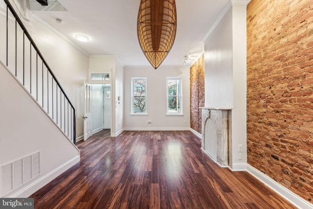 entryway featuring dark hardwood / wood-style flooring and ornamental molding