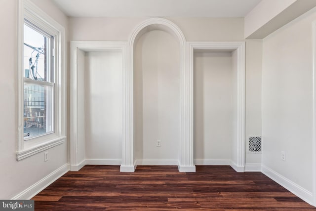 empty room with dark wood-type flooring