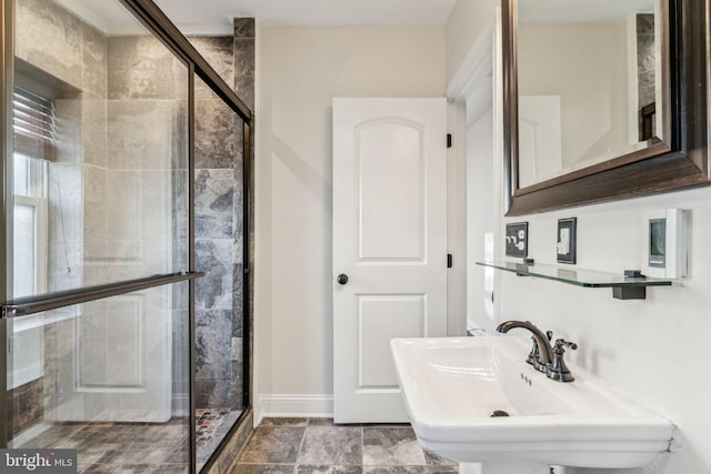 bathroom with sink and a shower with shower door