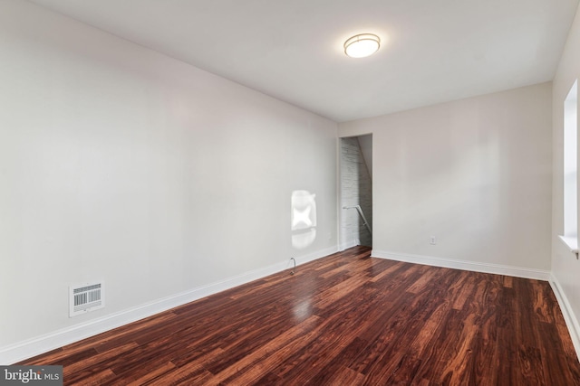 empty room with dark hardwood / wood-style floors