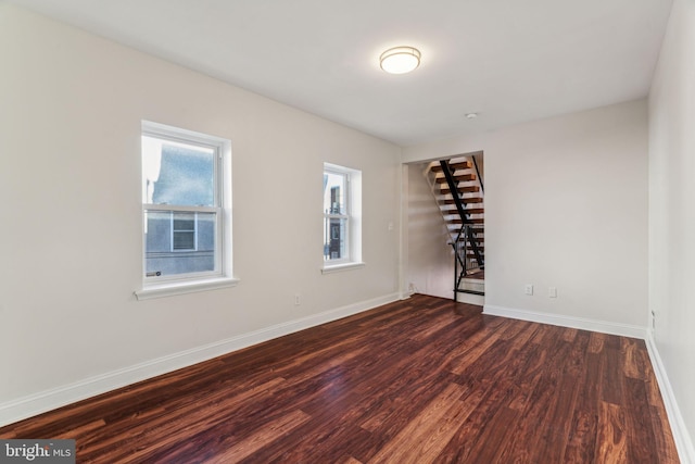 empty room with dark wood-type flooring