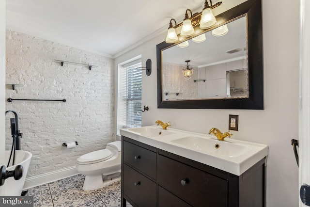 bathroom featuring toilet, vanity, tile patterned flooring, and ornamental molding