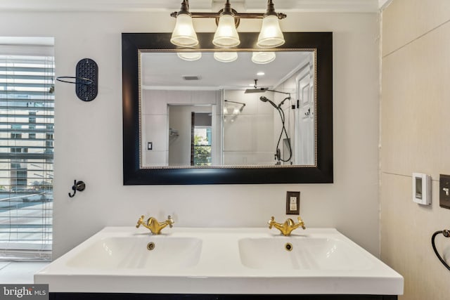 bathroom featuring a wealth of natural light, vanity, and crown molding