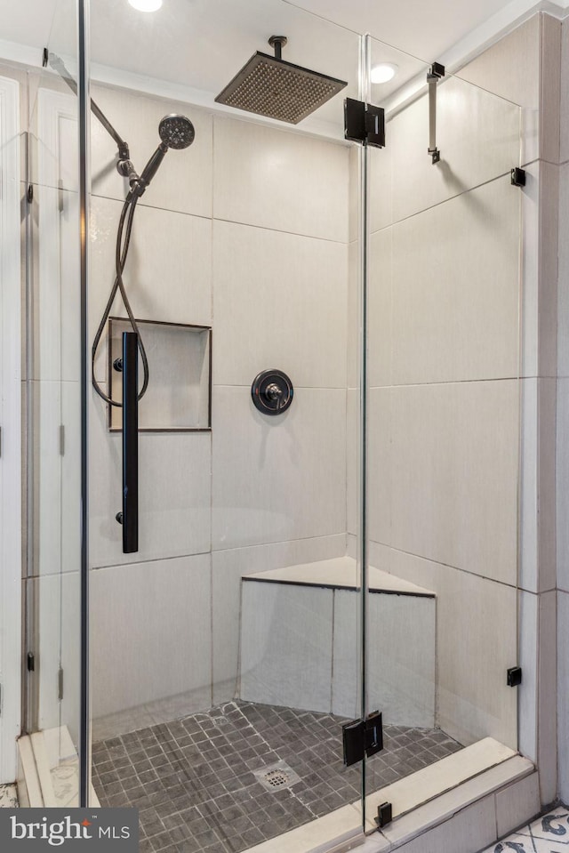 bathroom with a shower with shower door