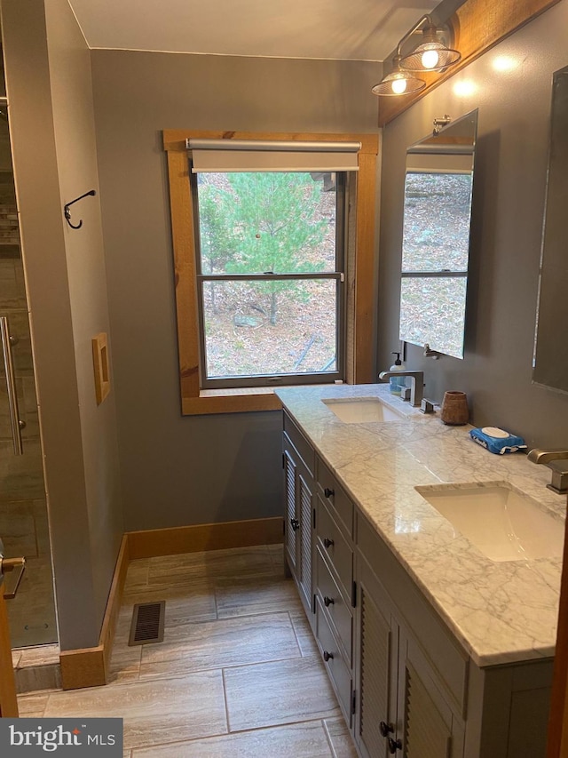 bathroom featuring walk in shower, vanity, and hardwood / wood-style flooring