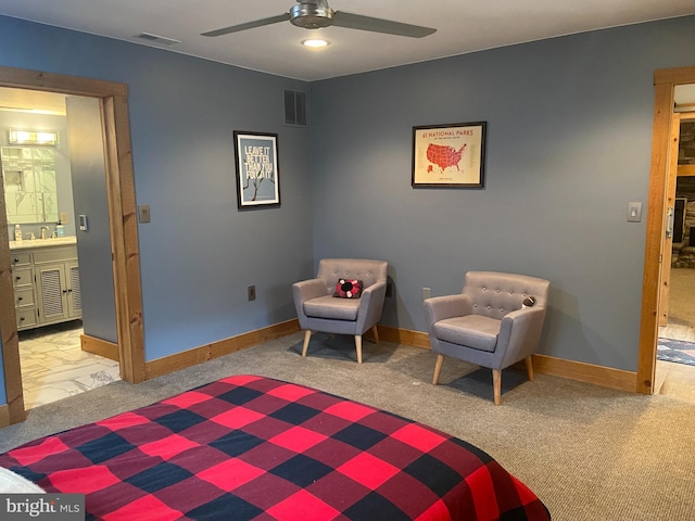 carpeted bedroom with ensuite bath, ceiling fan, and sink