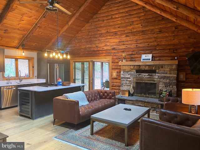 living room featuring light hardwood / wood-style flooring, high vaulted ceiling, and plenty of natural light