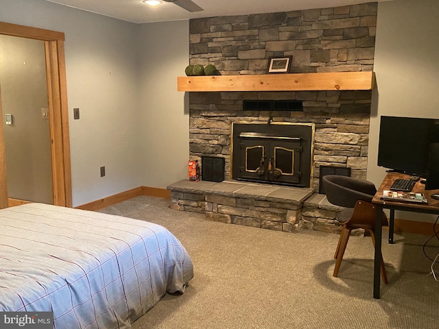 bedroom with light colored carpet and a fireplace