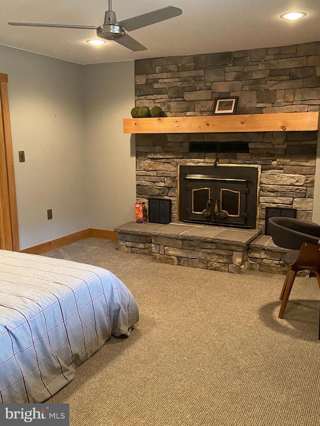 carpeted bedroom with a fireplace