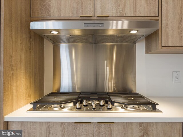 1607 Germantown Ave, Philadelphia, PA 19122 - kitchen view of under cabinet range hood, light brown cabinetry, and stainless steel gas cooktop