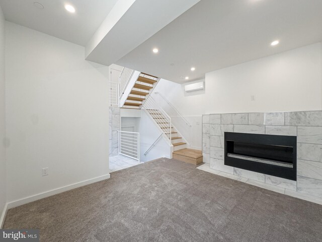 1607 Germantown Ave, Philadelphia, PA 19122 - unfurnished living room with carpet flooring, stairs, a fireplace, recessed lighting, and a wall mounted AC