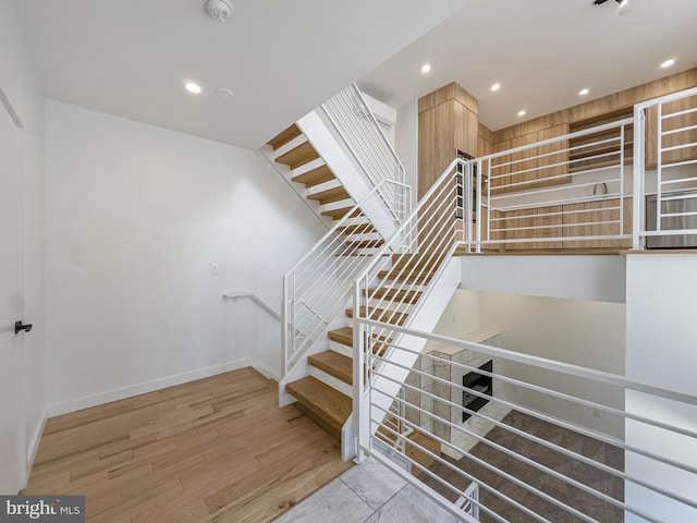 stairway featuring wood-type flooring