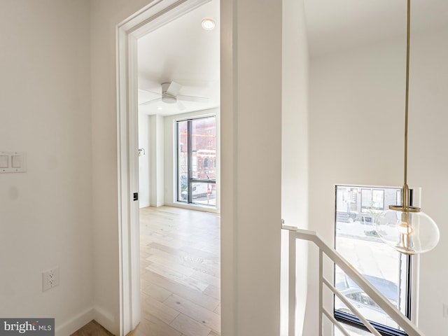 corridor with light hardwood / wood-style floors