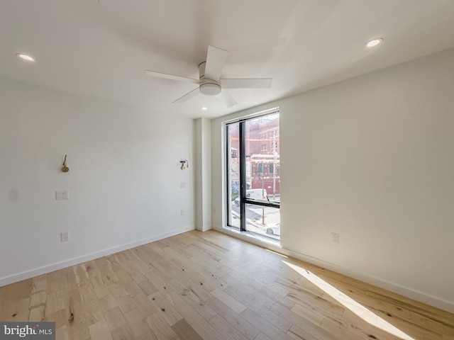 unfurnished room with light wood-type flooring and ceiling fan