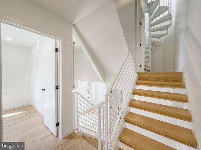 stairs with hardwood / wood-style flooring