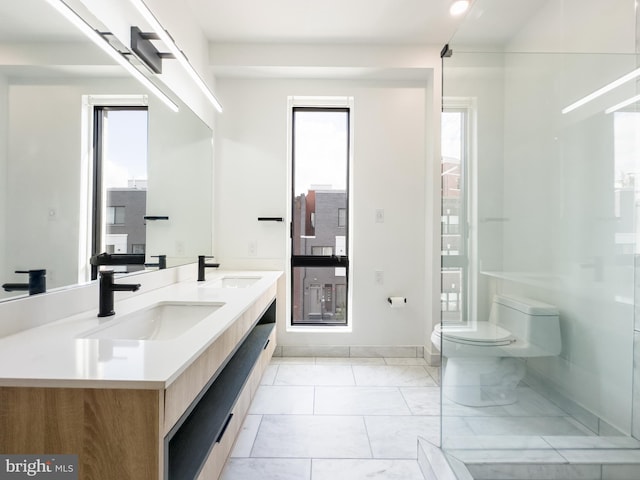 1607 Germantown Ave, Philadelphia, PA 19122 - bathroom featuring toilet, double vanity, and baseboards