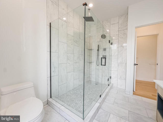 bathroom with toilet, vanity, hardwood / wood-style flooring, and a shower with shower door