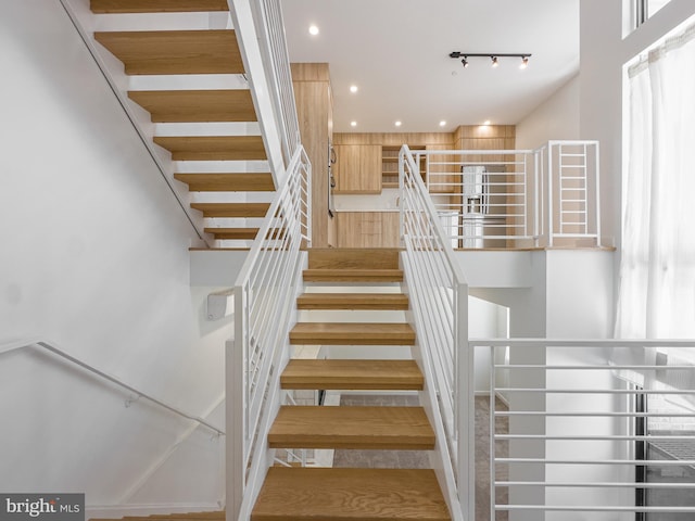 stairs featuring hardwood / wood-style floors