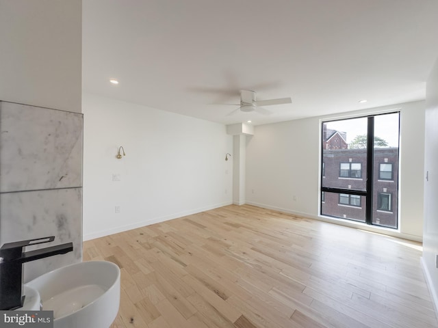 interior space featuring light hardwood / wood-style floors, ceiling fan, and sink