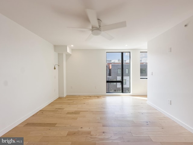 spare room with light hardwood / wood-style floors and ceiling fan