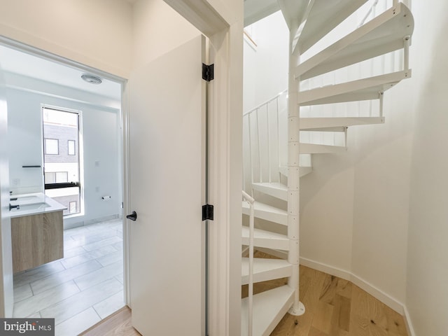 stairs featuring hardwood / wood-style floors