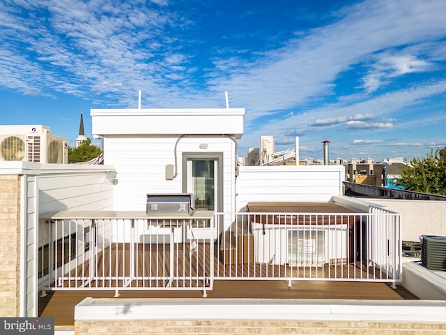 rear view of property featuring central AC and a balcony