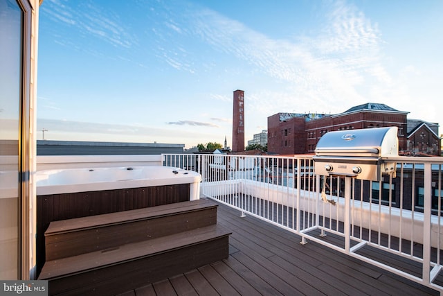 deck with a hot tub and grilling area