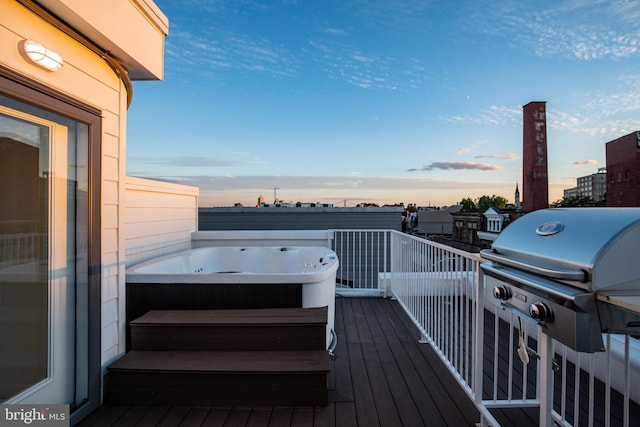 deck at dusk featuring area for grilling