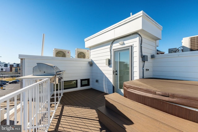 deck with a covered hot tub