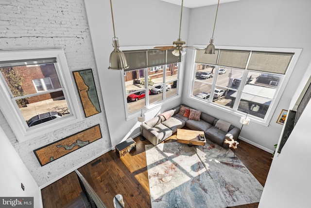 living room featuring hardwood / wood-style flooring, ceiling fan, and lofted ceiling