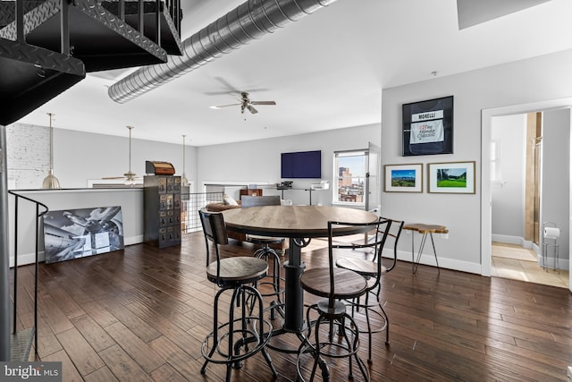 dining area featuring ceiling fan and dark wood-type flooring