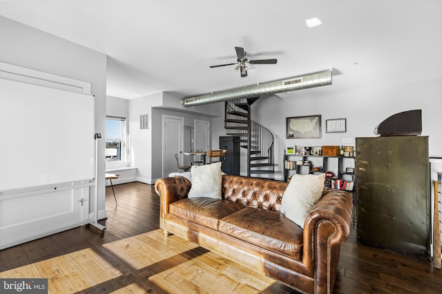 living room featuring ceiling fan and hardwood / wood-style flooring