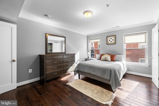 bedroom with dark hardwood / wood-style floors and crown molding