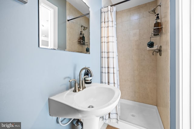 bathroom with sink and a shower with shower curtain