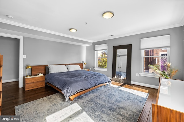 bedroom featuring crown molding and dark hardwood / wood-style flooring