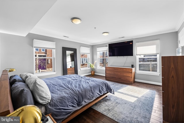 bedroom featuring wood-type flooring and crown molding