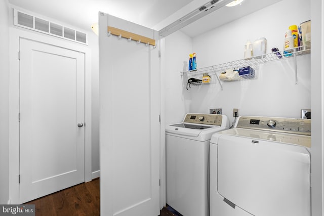 washroom featuring dark hardwood / wood-style flooring and separate washer and dryer