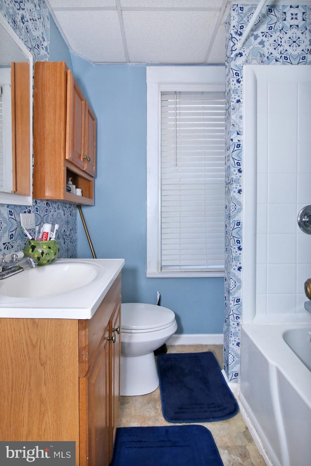 full bathroom with backsplash, a paneled ceiling, vanity, and toilet