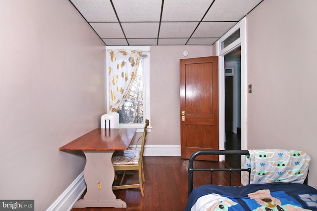 bedroom featuring radiator, dark hardwood / wood-style floors, and a drop ceiling