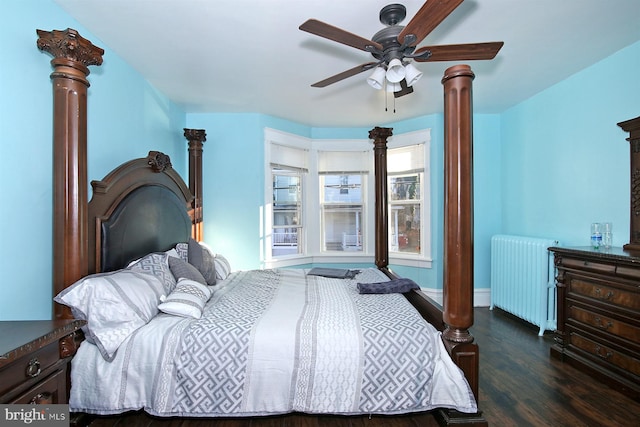 bedroom featuring decorative columns, dark hardwood / wood-style flooring, ceiling fan, and radiator heating unit