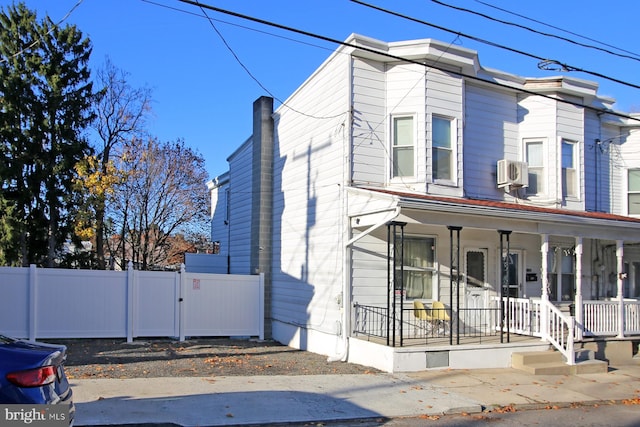 view of front of home with cooling unit and covered porch