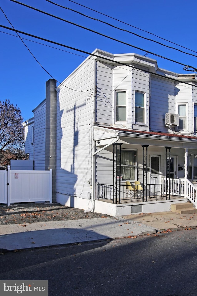 view of front of home featuring a porch and cooling unit